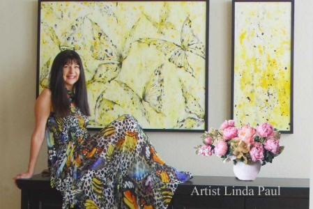 artist Linda Paul with yellw butterfly paintings