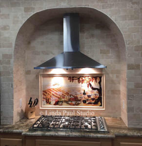 vineyard backsplash in arched stove alcove