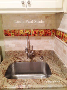 sunflower accent tile in laundry room sink space