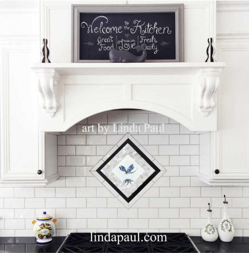 black and white kitchen with blue dragonfly medallion